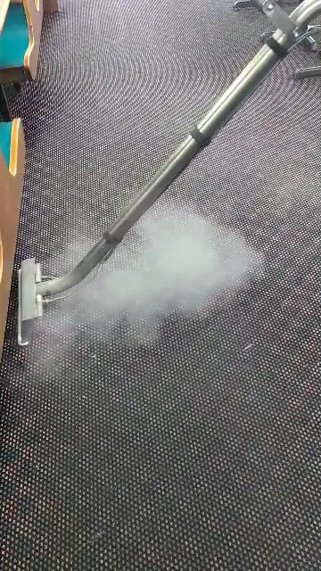 Steam rising from a carpet during hot-water extraction